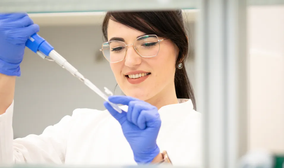 Scientist with a pipette in a lab